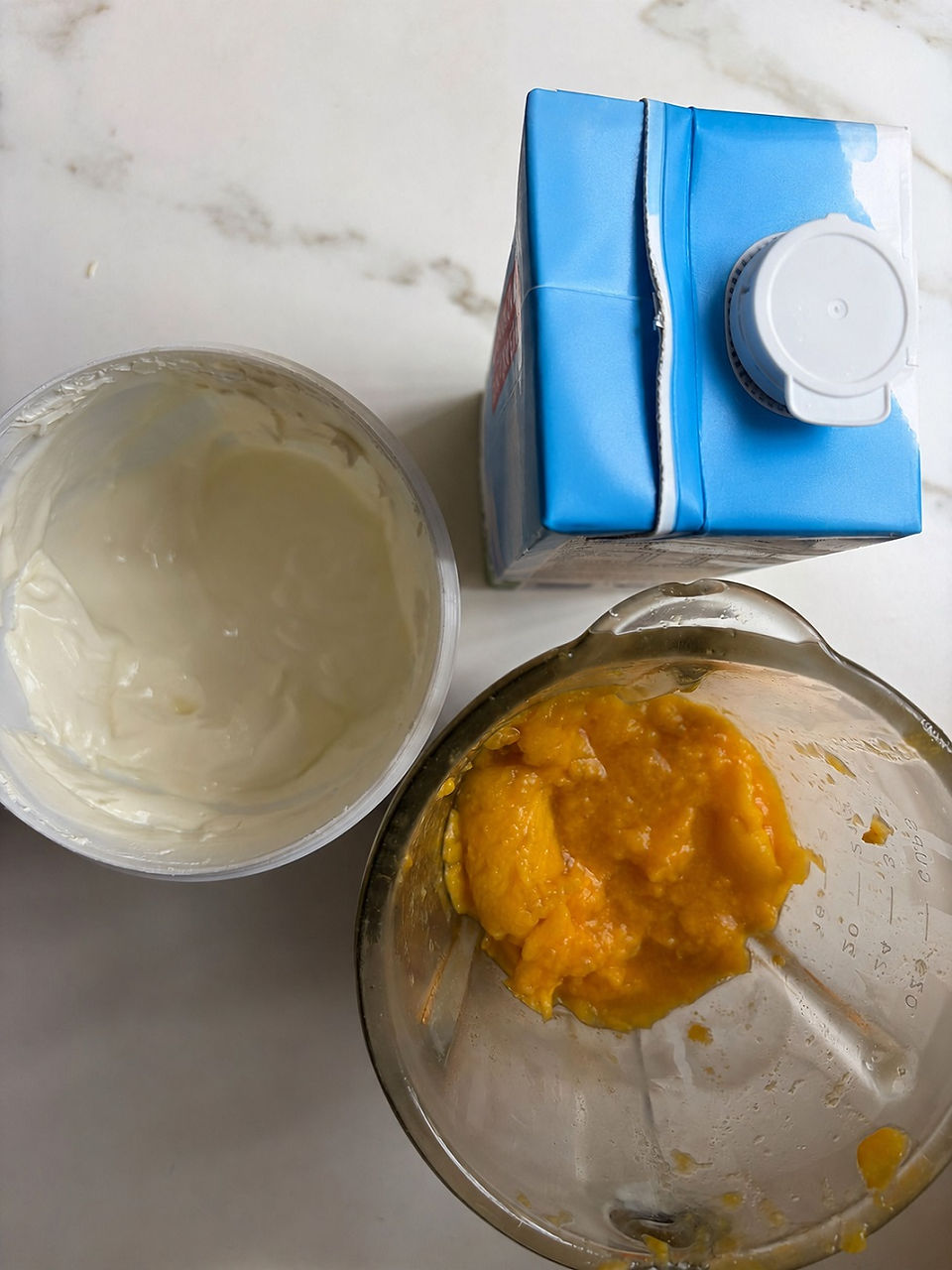 Fresh mango puree with milk and yogurt prepared for smooth mango lassi