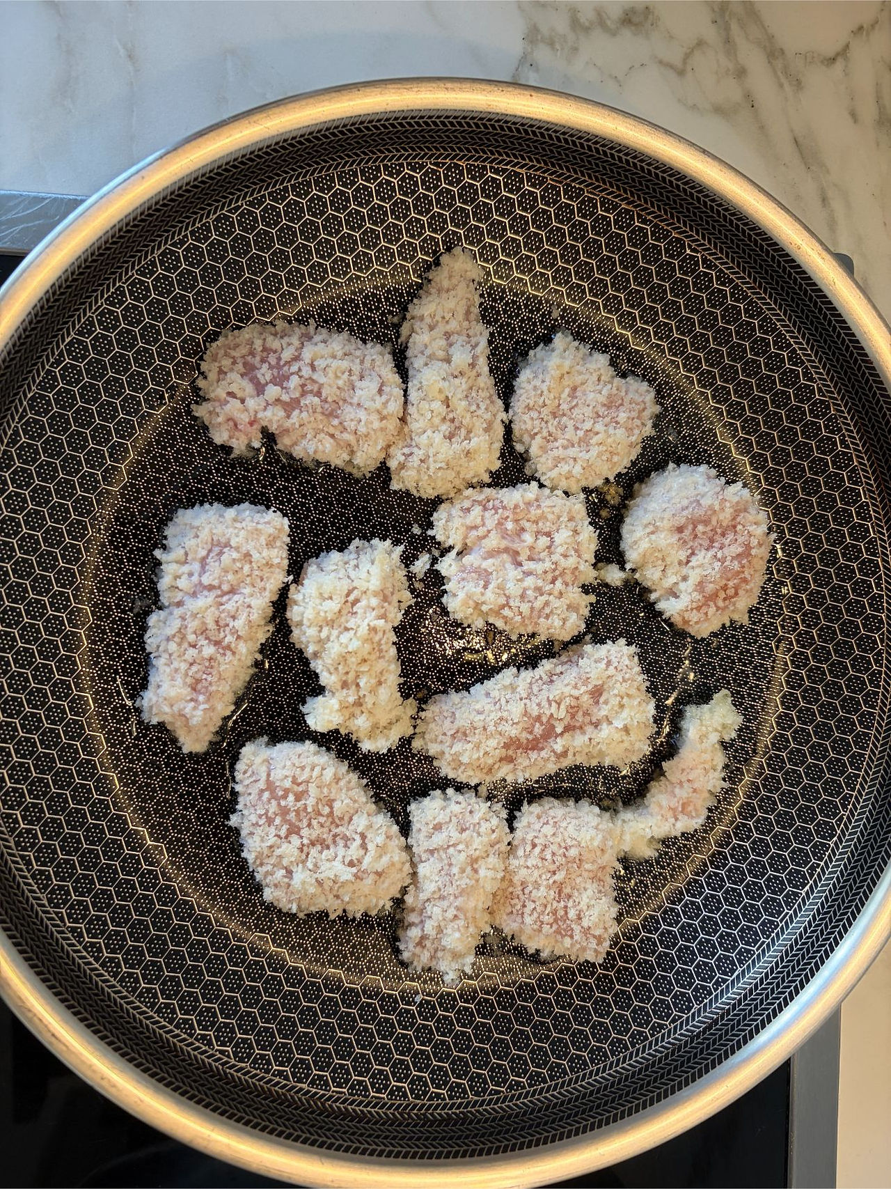 Frying the panko coated chicken until golden brown for the chicken salad