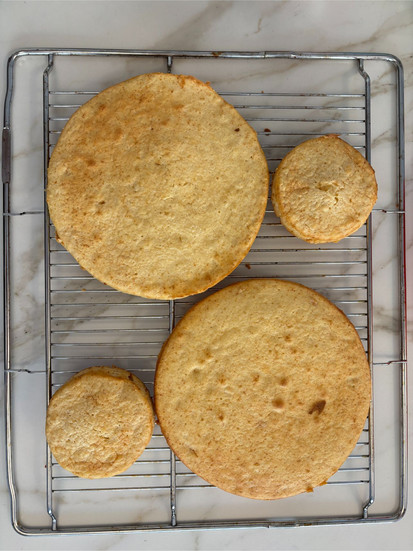 freshly baked dulce de leche sponge cake cooling on rack with light airy structure