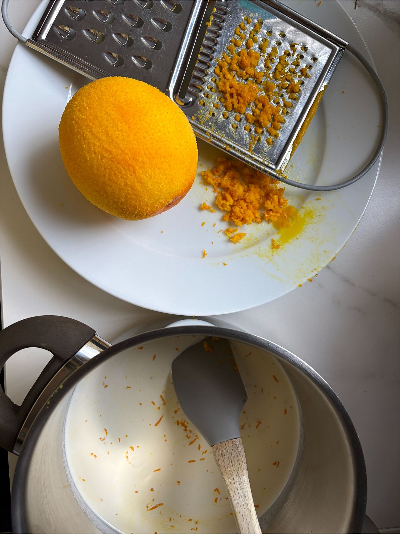Fresh orange zest being prepared for orange infused chocolate cake ganache