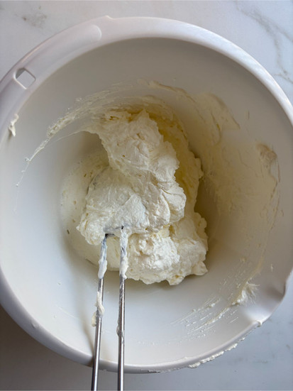 light and airy mascarpone cream ready for spreading on dulce de leche layered cake