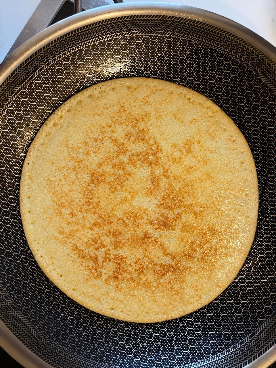 Golden brown French crêpe cooked to perfection and ready for filling with caramelized bananas