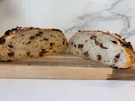 Artisan sourdough bread on wooden cutting board showing how flour choice affects crust and structure