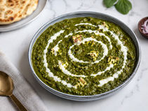 Authentic Palak Paneer Ready to Serve in a Traditional Indian Cooking Pot with Creamy Spinach Gravy and Paneer Cubes