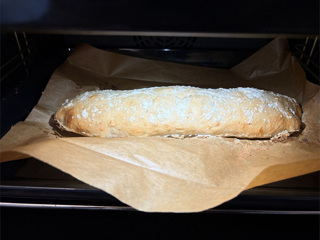Golden sourdough ciabatta baking in the oven with a crisp artisan crust