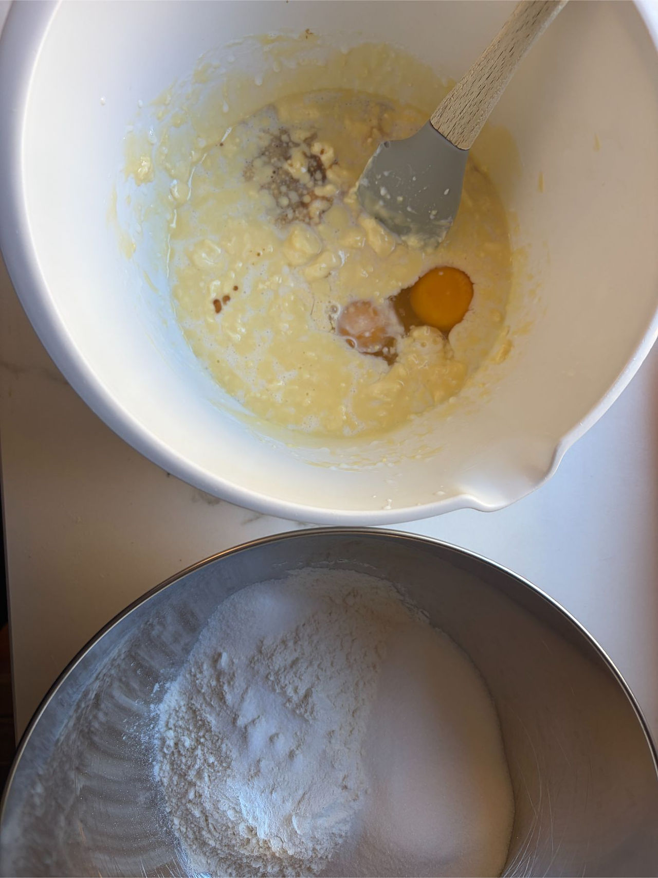 Folding wet ingredients into dry ingredients to create tender Cinnamon Swirl Coffee Muffin batter