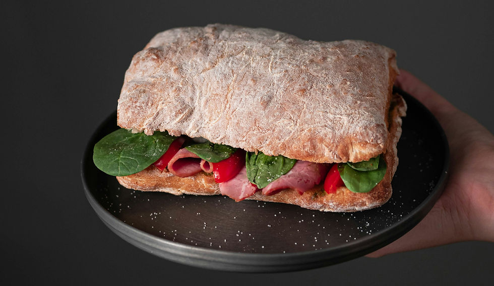 Sourdough ciabatta served with fresh vegetables, showcasing an open crumb and crisp artisan crust