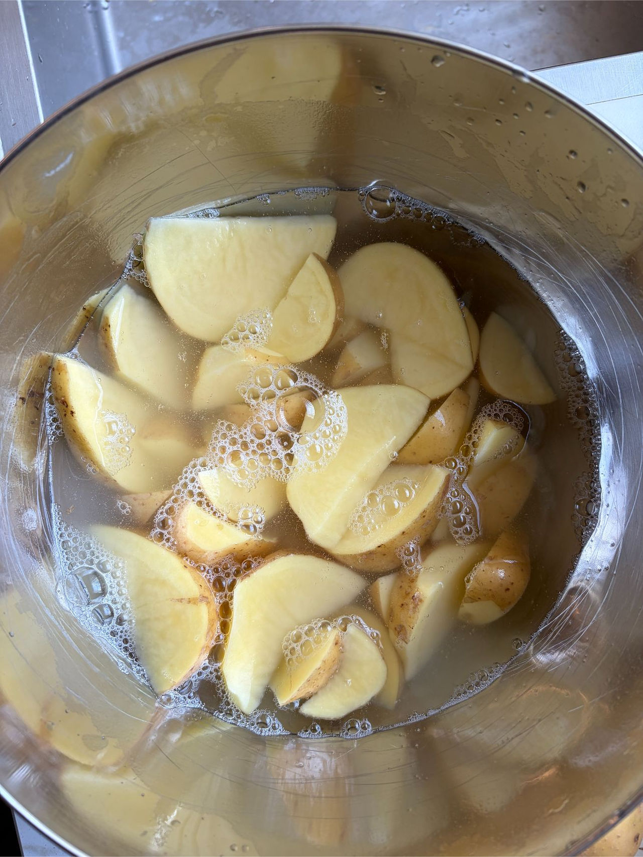 Cutting fresh potatoes into evenly sized wedges for oven roasting