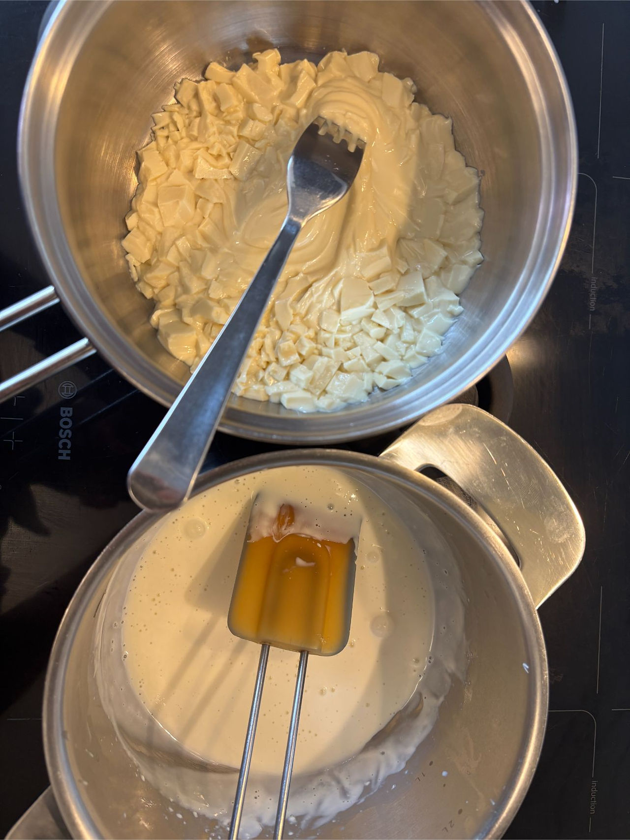 Half melted white chocolate next to dissolved gelatin mixture