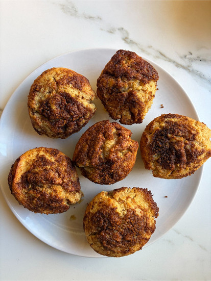 Bakery-style Cinnamon Swirl Coffee Muffins served on a clean plate with visible cinnamon swirls