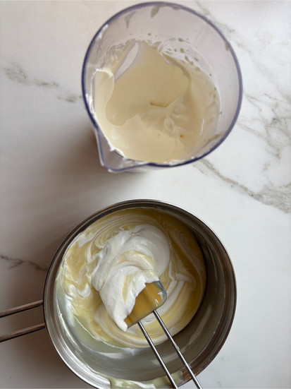 Folding whipped cream into white chocolate mixture