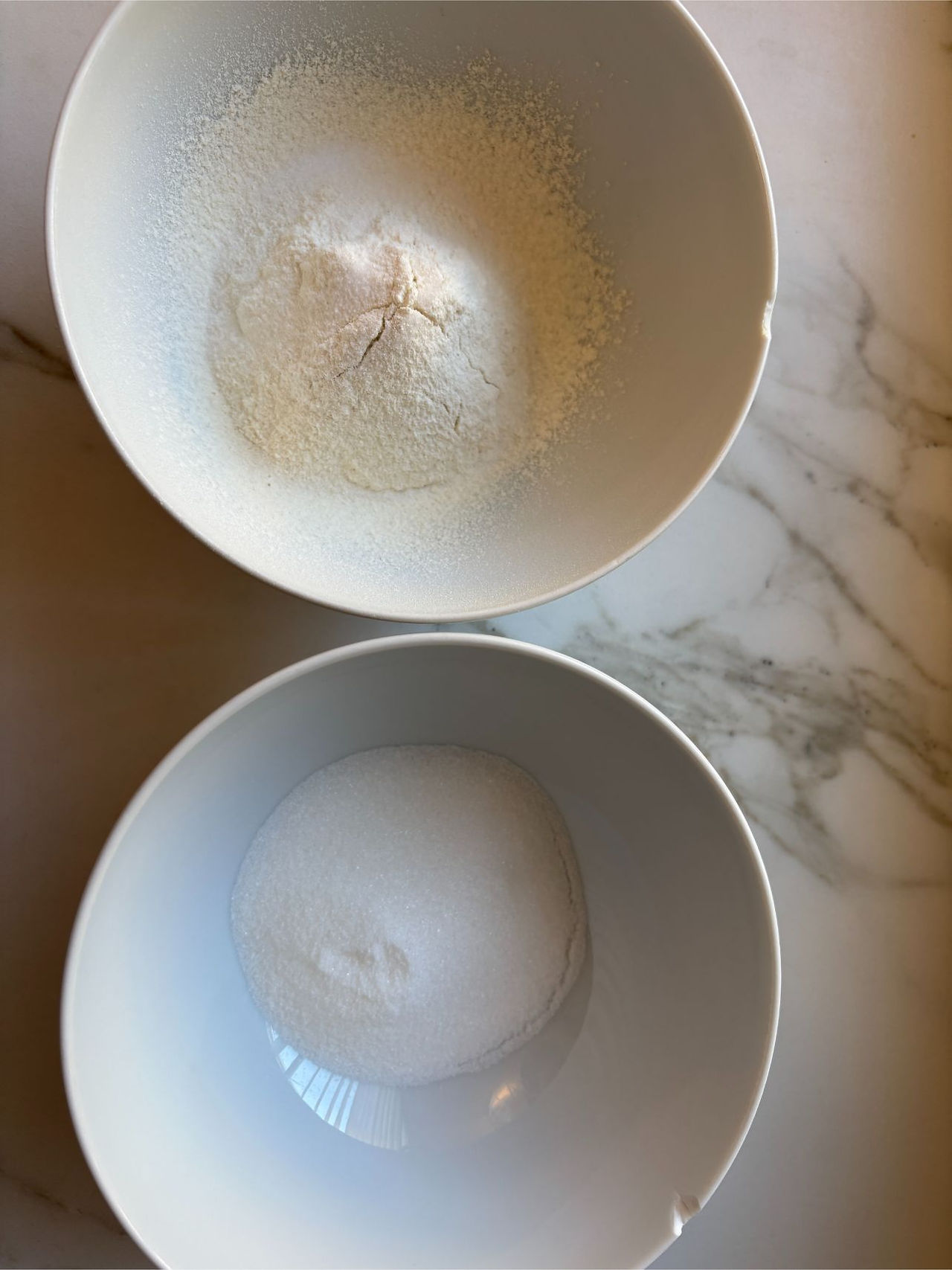 Sifting granulated sugar and flour for light sponge biscuit batter