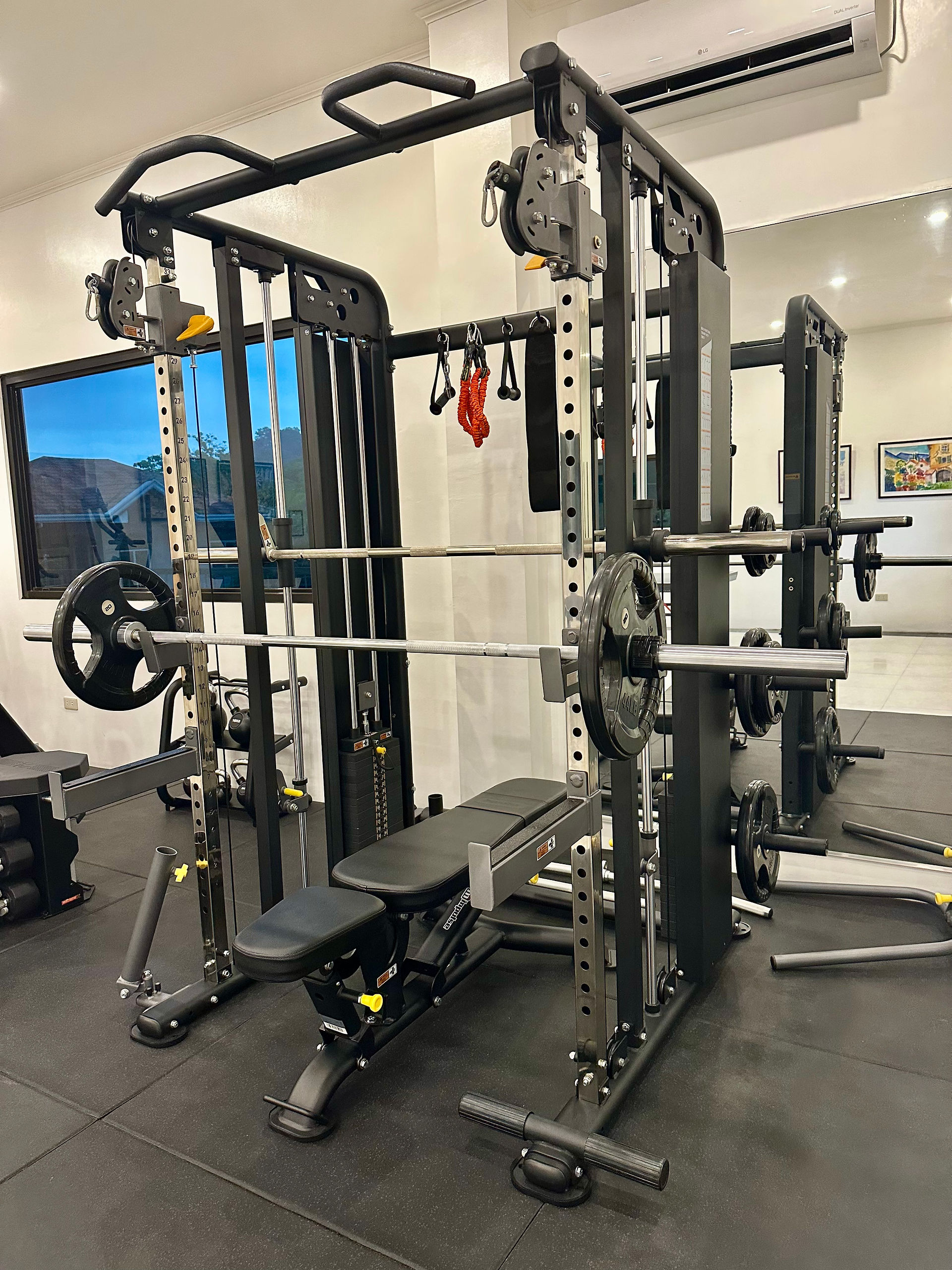 ES2100 strength training rack with Smith trainer and Olympic bar in the hotel gym of Strutz Art Garden Resort, boutique hotel in Bangued, Abra