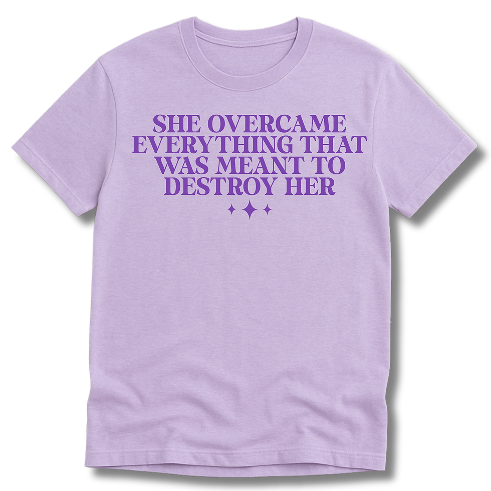 lilac colored short sleeve t-shirt with words "she overcame everything that was meant to destroy her"