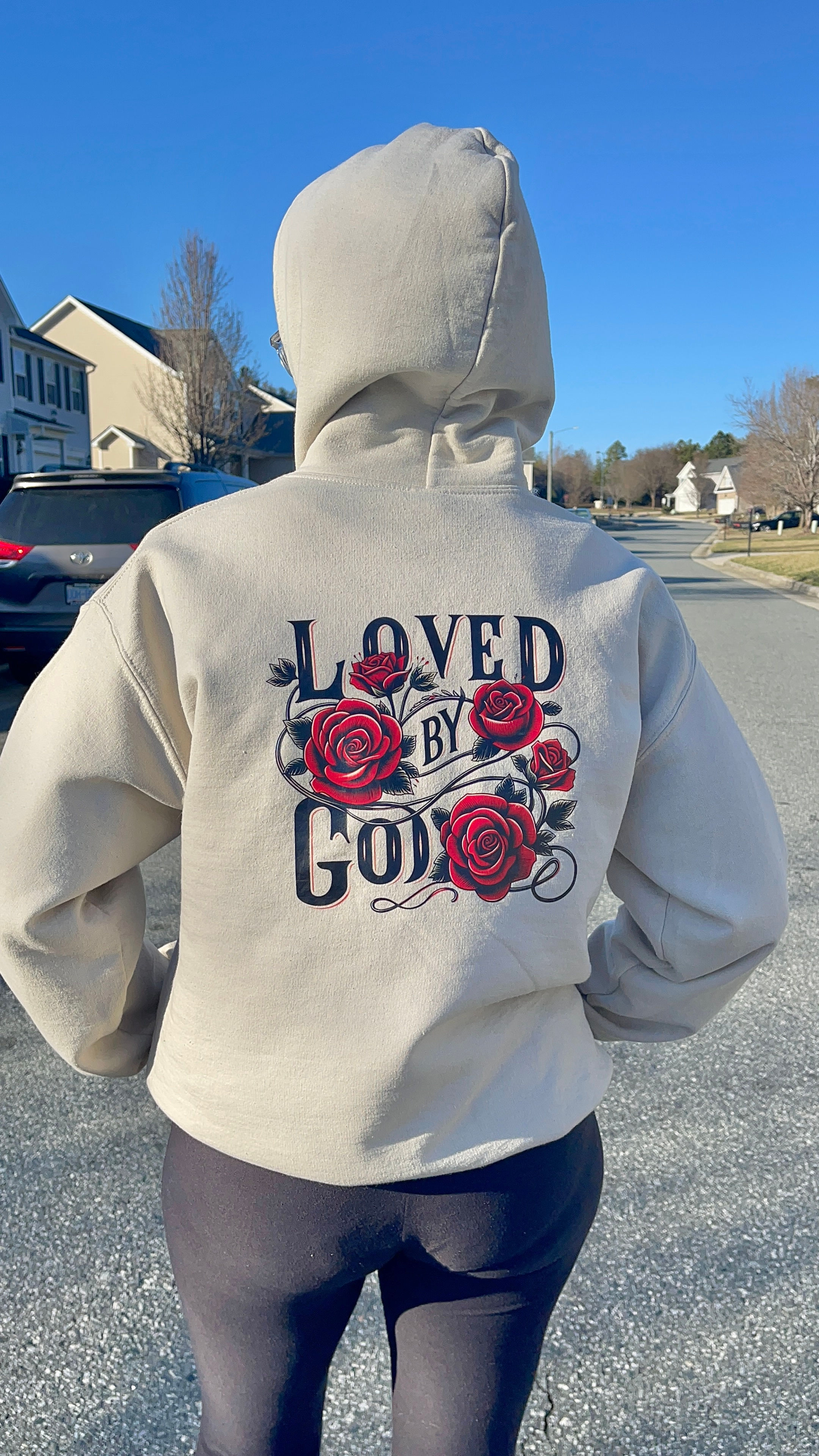 sand colored hoodie with loved by God graphic design with roses and green vines
