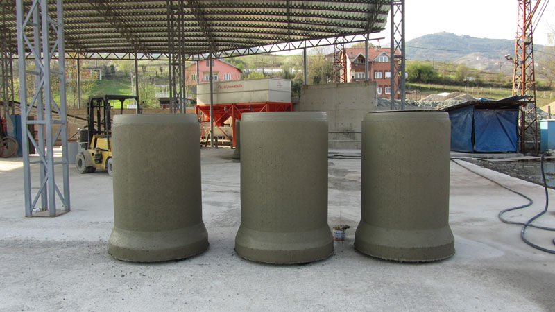 Large industrial concrete culvert pipes displayed at an outdoor manufacturing facility.