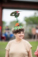 Woman wearing a hummingbird hat at the Parade of Birds.