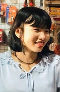Young smiling Myanmar woman in grey blouse