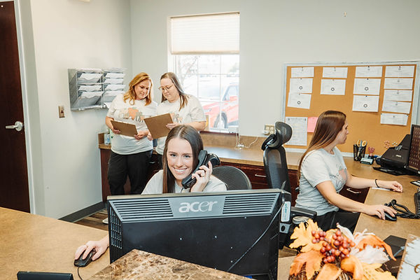 Smile Stop front office team assisting patients by phone and at the reception desk