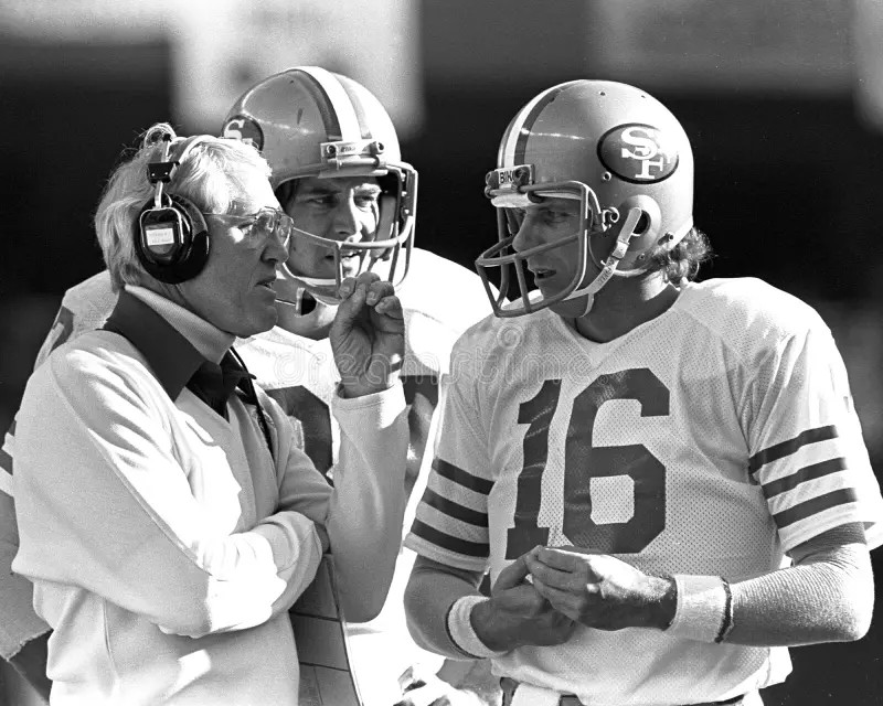 Bill Walsh, Head Coach of the 49ers, conferring with Joe Montana