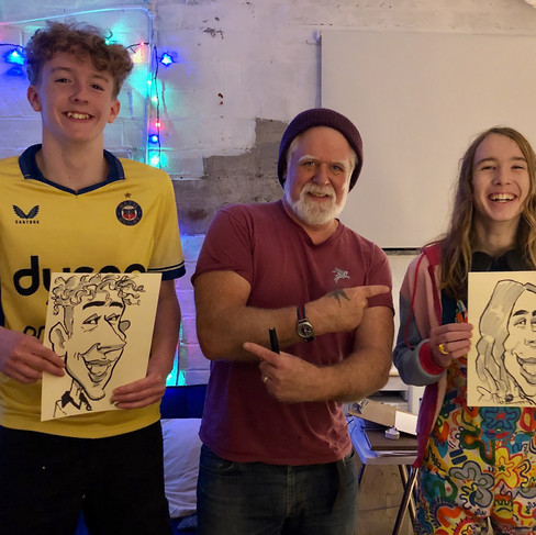Caricaturist with bearded man at party in Wiltshire
