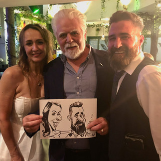 Caricaturist with wedding guests in Leicester