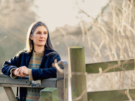 Woman walking outdoors after injury, reflecting on returning to exercise with nervous system awareness
