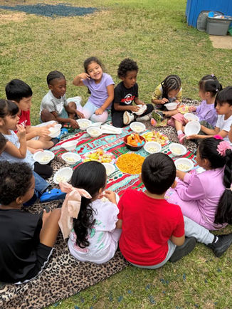 Pre-K children having an outdoor picnic at New World Academy in Norcross, GA.