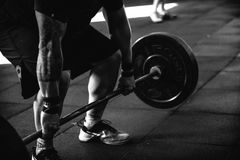 photo of a man lifting a barbell deadlift style