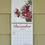 Thumbnail: December 2025 calendar spread with candy cane dahlia, white pine, fern seed pod, pinecones, and juniper