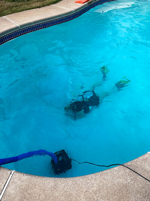 TPB technician using diving gear to check a main drain