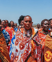 Women in traditional dress walking towards the camera