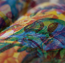 A close up photo of a magazine page, with layers of brightly coloured line work depicting leaves