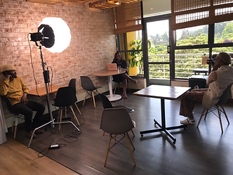 A studio set up with lighting and a camera in place