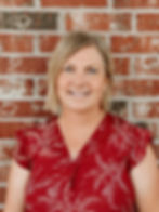 Female therapist smiling in professional headshot, EMDR certified specialist.