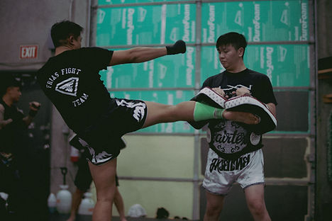 bowen solo kicking thai pads.JPG