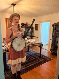 Sparrow of The Resonant Rogues drinks from a mug before her performance.