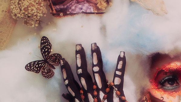 Cropped photograph of a woman painted as La Catrina with skeleton figures and decorative skull makeup, surrounded by fluffy clouds and butterflies.