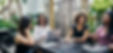 Small group of people conversing around a table