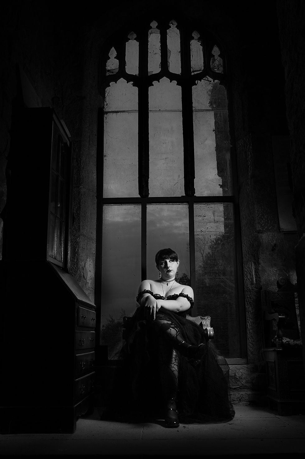 Wide angle view of the castle grounds with Tyler posing near an ancient archway