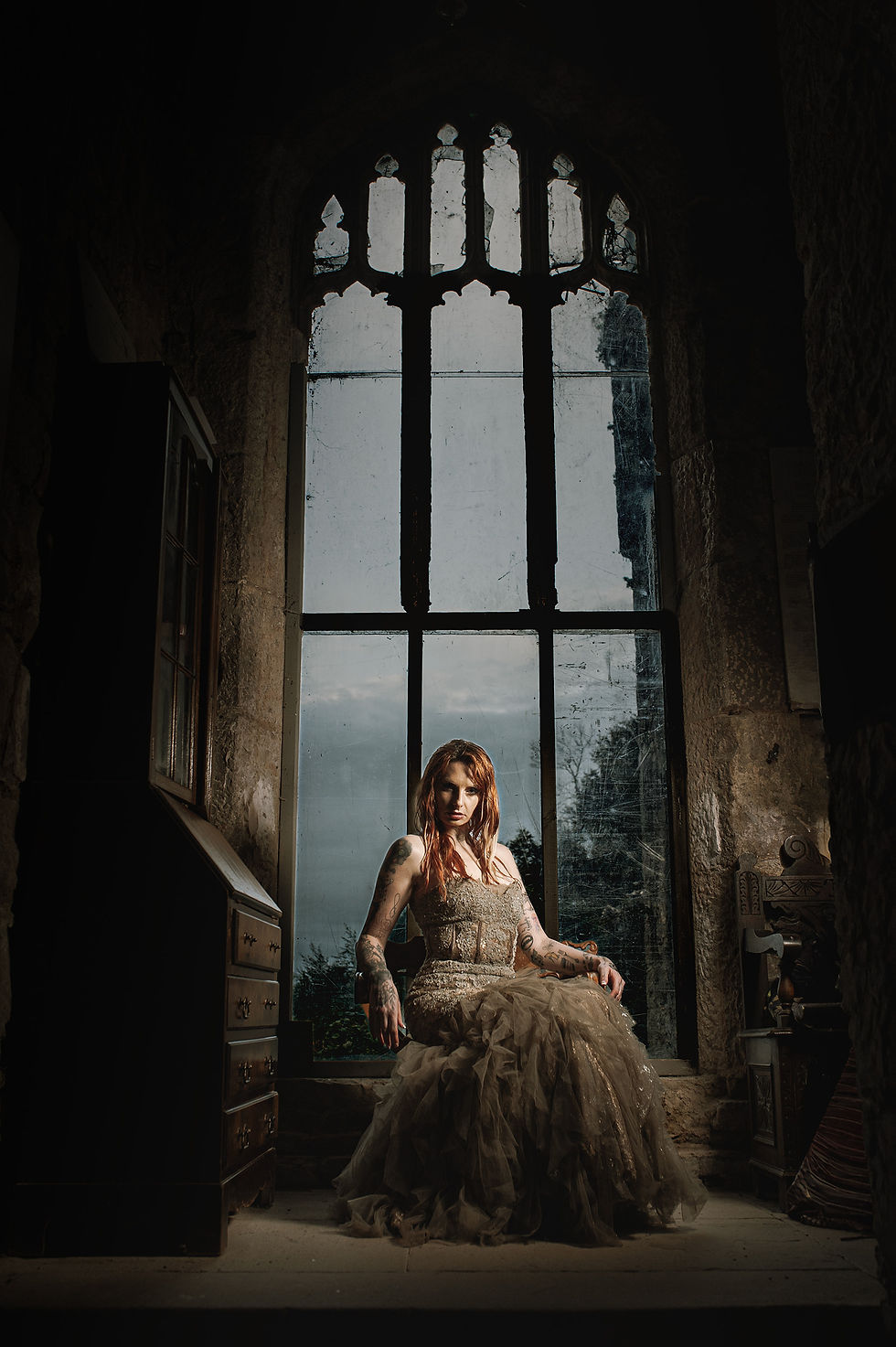 Close-up view of Jaime standing near a castle window with dramatic shadow play