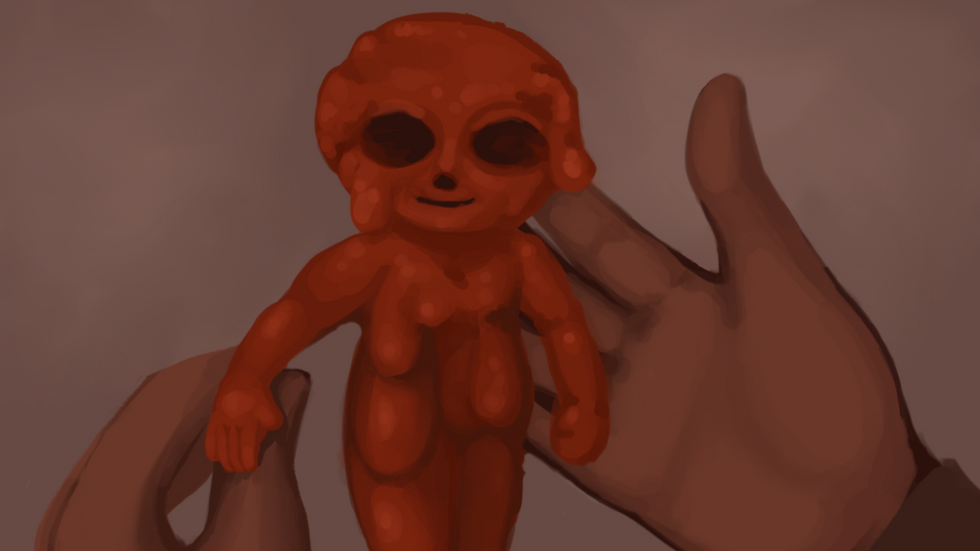 A small humanoid is gently held by human hands.