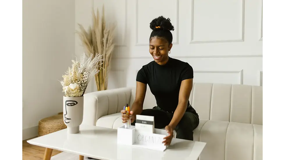 Smiling woman who knows how to organize her busy life using a desk organizer and colorful pens on a coffee table.