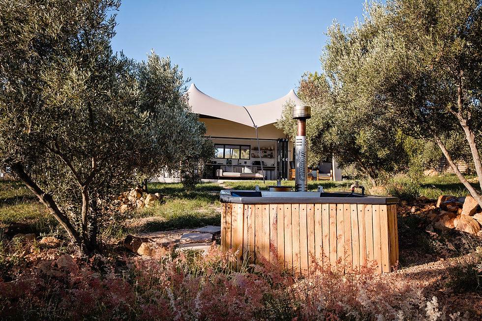 The Olive Mountain Lodge exterior and private wood-fired hot tub at Ronwe Farm Estate