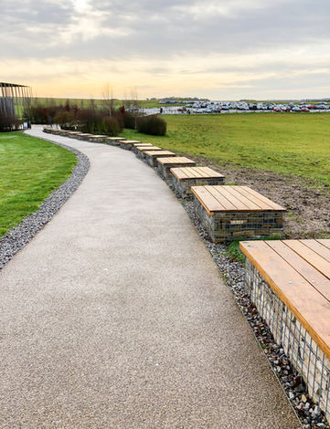 Public realm work at Stonehenge - gabion benches lining a paved footpath