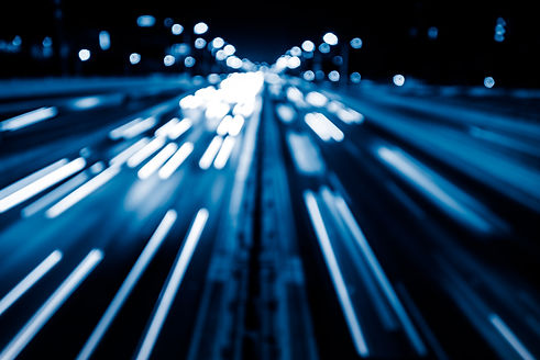 Fast-moving lights symbolizing energy grid and battery storage innovation