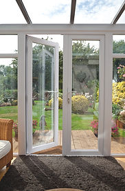 set of white uPVC double doors with one pane wider than the other and two side glass panes with clear glass