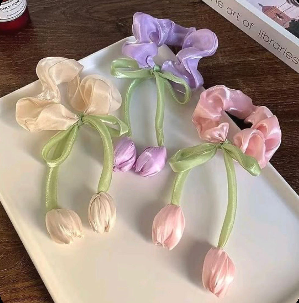 Three pastel Tulip Bow Hair Scrunchies displayed beautifully on a white tray.