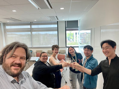 A selfie of the Musser Lab raising a toast