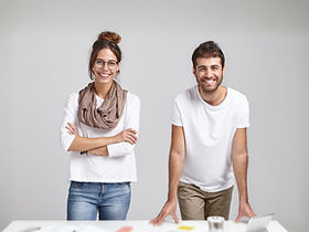 young-coworkers-standing-near-desk (1)_edited_edited.jpg